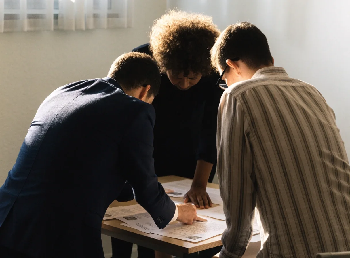 An agency team reviewing engagement notes across a light meeting table
